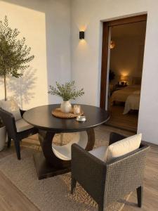 a living room with a table and chairs and a bedroom at Hotel Berati in Prizren