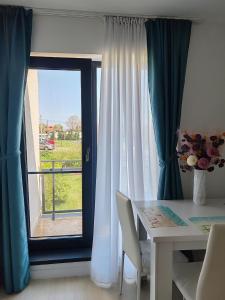 a table and chairs in front of a window at Cozy apartment Vama Veche in Vama Veche +7 photos