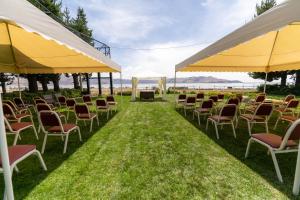 a group of chairs sitting under umbrellas on the grass at Hotel Jose Antonio Puno in Puno