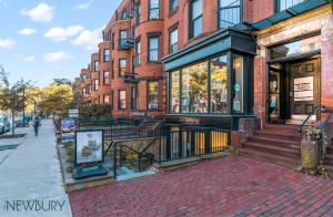 a brick building with a store on a street at 304 Newbury Street by Thatch in Boston