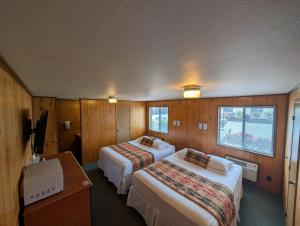 a hotel room with two beds and a window at The Orca Inn in Friday Harbor