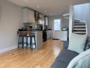 a kitchen and living room with a couch and a table at 3 Harbour Lights, Newlyn in Penzance