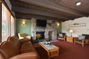 a living room with a couch and a fireplace at Seven Springs Resort Properties by Vail Resorts in Champion