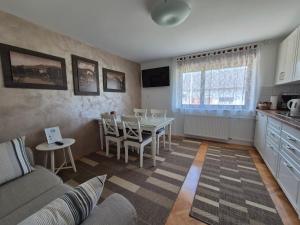 a living room with a couch and a table at Apartments & Rooms Aleksandra in Bled
