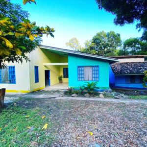a house with a blue and yellow facade at Overlooking Budget Hotel in San Pedro Sula