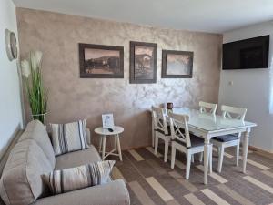 a living room with a table and a couch at Apartments & Rooms Aleksandra in Bled