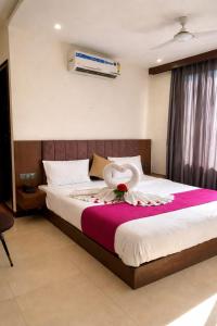 a bedroom with a bed with a flower on it at Hotel maharaja in Udaipur