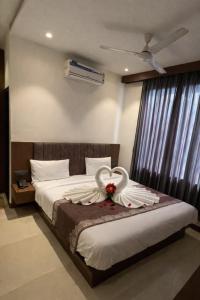 a bedroom with a bed with a swan decoration on it at Hotel maharaja in Udaipur