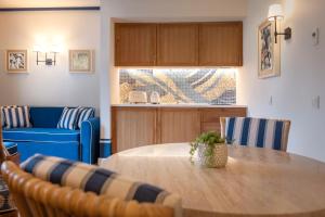 a living room with a table and a blue couch at Grande Real Santa Eulalia Resort & Hotel Spa in Albufeira