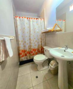 a bathroom with a toilet sink and a shower curtain at Colonial San Lazaro Apart Hotel in Arequipa +42 photos