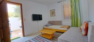 a small room with a bed and a tv in it at Dar Mnasri in Houmt Souk