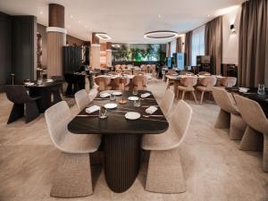 a restaurant with a table and chairs and tables and tablesktop at Diaco Boutique Hotel in Đakovo