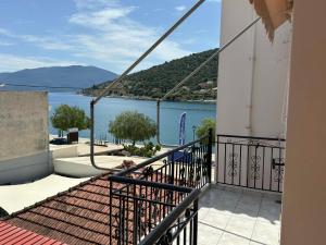a balcony with a view of a body of water at Pelagias Apartments in Agia Effimia