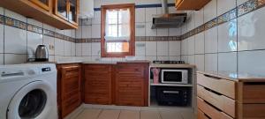 a kitchen with a washing machine and a washer at Dar Mnasri in Houmt Souk