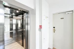 a elevator in a room with a door at Apartmán Kolonáda in Poděbrady