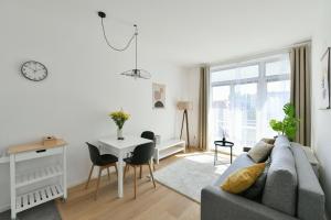 a living room with a couch and a table at Apartmán Kolonáda in Poděbrady +9 photos