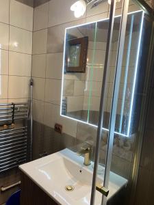 a bathroom with a sink and a mirror at Oasis House in Hunedoara +8 photos