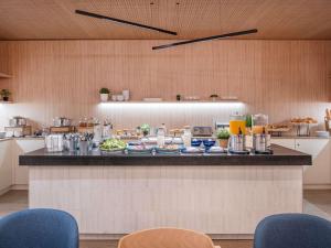 a kitchen with a counter with food on it at Novotel Marseille Centre Gare in Marseille +77 photos