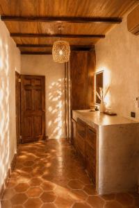 a kitchen with a table and a wooden ceiling at Casona Tunan in Santa María Mizata +70 photos