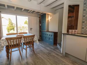 a kitchen with a table and chairs and a window at Pearls Farm One in Macclesfield +18 photos
