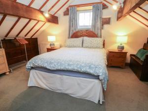 a bedroom with a large bed and a window at Pearls Farm One in Macclesfield