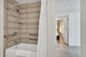 a bathroom with a tub and a shower curtain at Nola Retreat Next To Frenchmen & French Quarter in New Orleans +47 photos