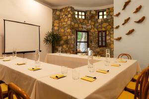 a meeting room with two tables with yellow napkins and glasses at Hotel Santa Fe in Puerto Escondido +65 photos