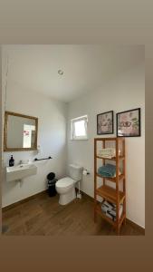 a bathroom with a toilet and a sink and a mirror at Casa La Isla in Sagres +45 photos