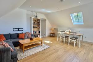 a living room with a couch and a table at The Hayloft in Ringwood