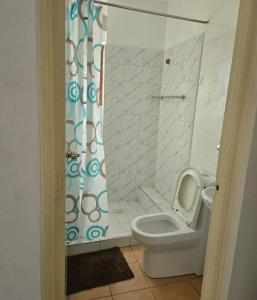 a bathroom with a toilet and a shower at Emeli Suites in Nairobi