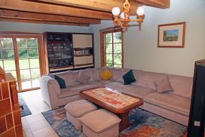 a living room with a couch and a table at Anglo-Polish Holidays in Chycina