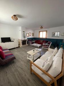 a living room with a white couch and a table at Casa La Isla in Sagres