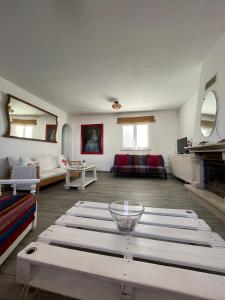 a living room with a table and a couch at Casa La Isla in Sagres