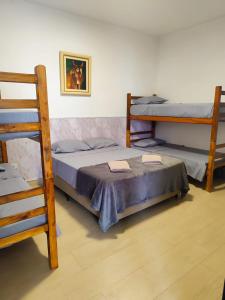 a bedroom with two bunk beds and a ladder at Pousada Espaço Vista Mar in Itanhaém +24 photos