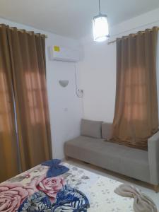 a living room with a couch and a window at Taguermess Tag 1 in Midoun