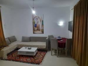 a living room with a couch and a table at Taguermess Tag 1 in Midoun