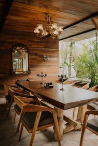 a dining room with a large wooden table and chairs at Casona Tunan in Santa María Mizata