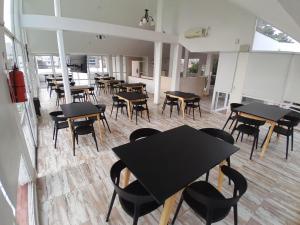 a room with tables and chairs in a restaurant at CRISTAL BuenaVista in Villa Carlos Paz