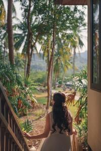 a woman in a wedding dress looking out of a window at Kooncharaburi Resort - Koh Chang in Ko Chang