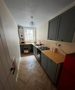 a small kitchen with a stove and a sink at 7 dodds lane alnwick in Alnwick