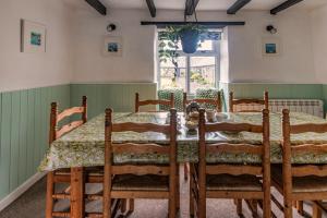 a dining room with a table and chairs at Courtyard Farm Cottages in Boscastle