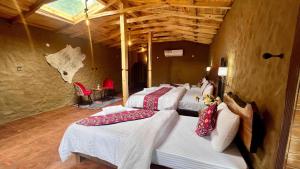 a group of beds lined up in a room at Trivor resort in Hunza Valley