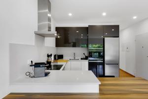 a kitchen with white counters and stainless steel appliances at JB RiaMar ll by Meditrust in Alvor