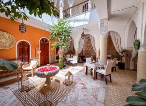 a lobby with tables and chairs in a building at Riad Nirvana in Marrakesh