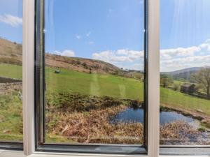 a window with a view of a field at Pearls Farm Two in Macclesfield