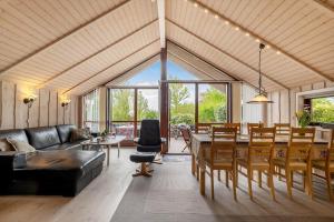 a large living room with a table and chairs at LF16031-Farso-Spydspidsevej-31 in Ertebølle