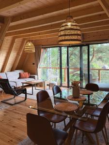 a living room with a table and chairs at Molika Forest House in Kolašin