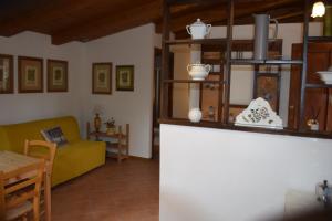 a living room with a yellow couch and a table at Camporegio in Civitella Cesi