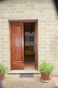 a wooden door in a brick building with a couch behind it at Camporegio in Civitella Cesi