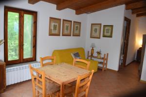 a living room with a table and a couch at Camporegio in Civitella Cesi